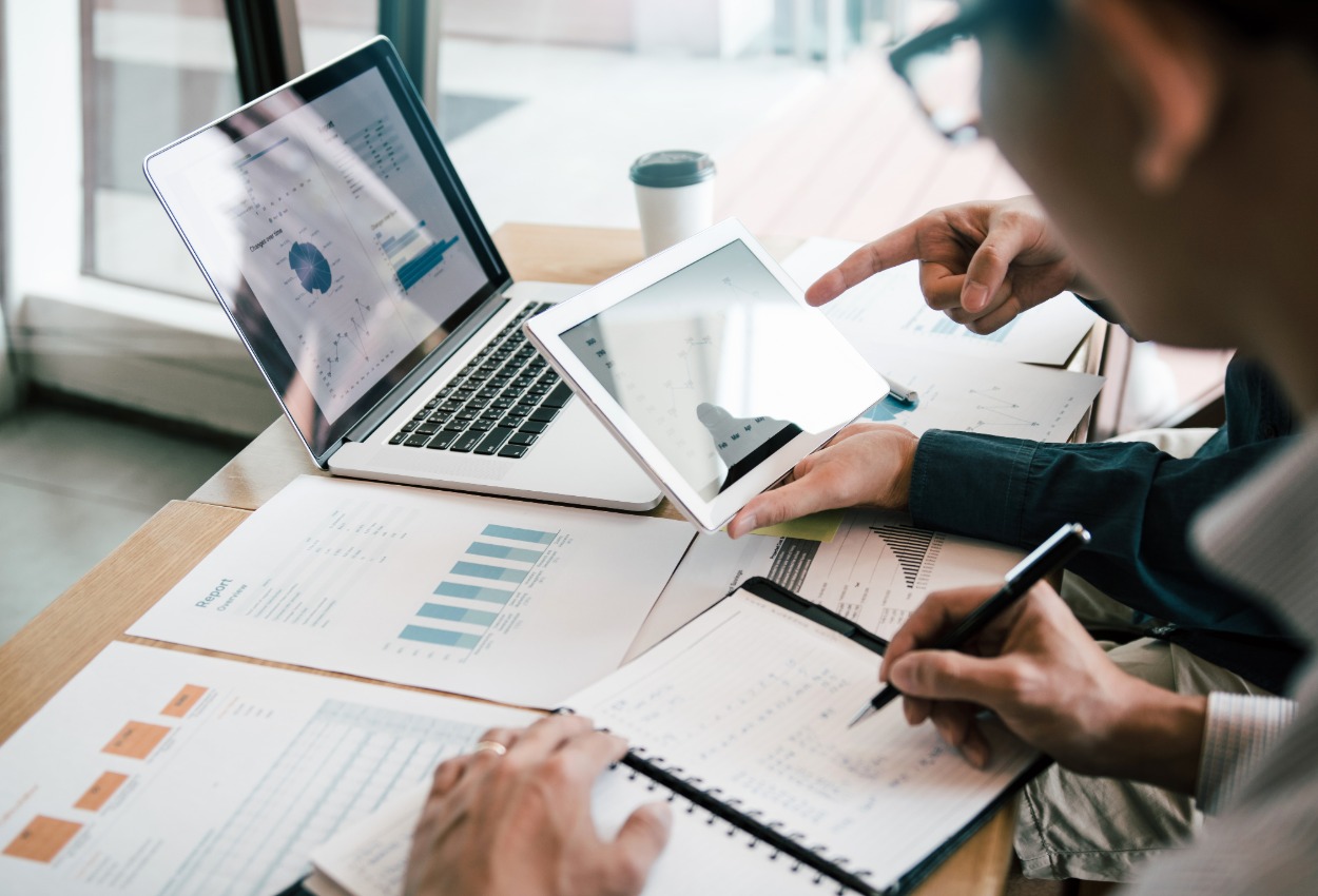 Financial advisor studying financial data for business planning strategies.